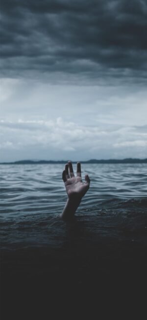 sad aesthetic wallpaper - moody image of hand in the ocean