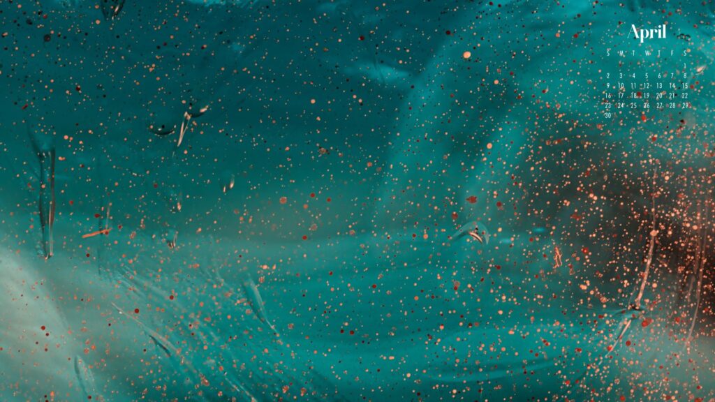 a desktop wallpaper of gold and red paint speckles on a painted aqua background