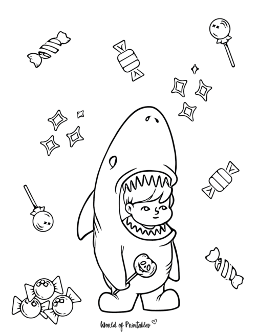 a cute kids in a shark costume with candy
