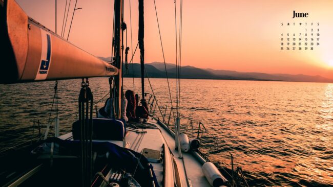 a boat at sea during sunset